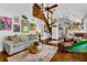 Open-concept living room and staircase featuring rustic stairs, neutral sofa, and bright accents at 1315 E 24Th St, Sanford, FL 32771
