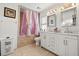 Bathroom featuring double sink vanity, tiled floors, and shower with curtain at 1321 Dunbarton Ct, Kissimmee, FL 34758