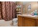 Cozy bathroom with a shower-tub combo and a dark, patterned shower curtain at 1321 Dunbarton Ct, Kissimmee, FL 34758