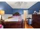 Bedroom with a dark-blue accent wall, ceiling fan, and warm laminate floors at 1321 Dunbarton Ct, Kissimmee, FL 34758