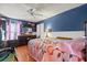 Spacious bedroom with hardwood floors, ceiling fan, and a large dresser at 1321 Dunbarton Ct, Kissimmee, FL 34758