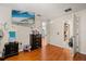 Bedroom with wood floors, light walls, ceiling fan and doorway to other rooms at 1321 Dunbarton Ct, Kissimmee, FL 34758