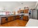 Bright kitchen with stainless steel appliances, laminate floors, and ample counter space at 1321 Dunbarton Ct, Kissimmee, FL 34758