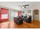 Spacious living room with hardwood floors, ceiling fan, and comfortable seating at 1321 Dunbarton Ct, Kissimmee, FL 34758
