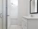 Bright bathroom with glass-enclosed shower and a vanity with lots of light and chrome hardware at 141 S. Park Ave, Winter Garden, FL 34787