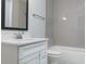 Modern bathroom features a combined tub and shower with white subway tiles and a vanity at 141 S. Park Ave, Winter Garden, FL 34787