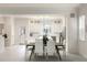 Bright dining area adjacent to the kitchen with modern furniture, creating a welcoming space for meals at 141 S. Park Ave, Winter Garden, FL 34787