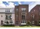 Beautiful brick townhome featuring a landscaped front yard, small balcony, and stylish modern design at 141 S. Park Ave, Winter Garden, FL 34787
