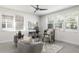 Bright home office with two large windows, a ceiling fan, and comfortable seating area with decorative rug at 141 S. Park Ave, Winter Garden, FL 34787