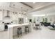 Open-concept kitchen with a breakfast bar, stainless appliances, and seamless flow into the living area at 141 S. Park Ave, Winter Garden, FL 34787