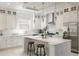 Beautiful white kitchen with subway tile backsplash, island seating, and stainless steel appliances at 141 S. Park Ave, Winter Garden, FL 34787