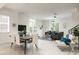 Open-concept living area with dining, comfortable seating, large windows, and modern decor at 141 S. Park Ave, Winter Garden, FL 34787