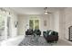 Bright living room with gray seating, natural light, and a stylish rug creates an inviting and relaxing atmosphere at 141 S. Park Ave, Winter Garden, FL 34787