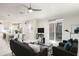 Bright living room features modern furnishings, a ceiling fan, and flows into the open kitchen and dining area at 141 S. Park Ave, Winter Garden, FL 34787