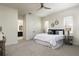Cozy main bedroom boasts ample natural light, a ceiling fan, and comfortable carpet at 141 S. Park Ave, Winter Garden, FL 34787