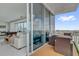 This balcony has a dining table and patio chairs with a clear view into the living room through sliding doors at 150 E Robinson St # 2111, Orlando, FL 32801