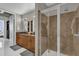Bright bathroom features a glass shower enclosure with tiled walls and double vanity at 150 E Robinson St # 2111, Orlando, FL 32801