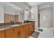 Bathroom with double vanity, granite counters, framed mirrors, and a glass-enclosed shower at 150 E Robinson St # 2111, Orlando, FL 32801