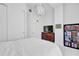 This bedroom features white walls, closet space, a dresser with a tv, and a bookshelf at 150 E Robinson St # 2111, Orlando, FL 32801