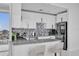 Modern kitchen with white cabinets, stainless appliances, granite counters and bar seating at 150 E Robinson St # 2111, Orlando, FL 32801