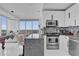 Modern kitchen with a breakfast bar overlooking the living space with floor to ceiling windows at 150 E Robinson St # 2111, Orlando, FL 32801