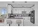 Modern kitchen with white cabinetry, stainless steel appliances, and a stylish tile backsplash at 150 E Robinson St # 2111, Orlando, FL 32801