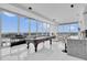 Bright living room with floor-to-ceiling windows, pool table, piano, bar seating and views at 150 E Robinson St # 2111, Orlando, FL 32801