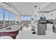 Bright living space with a pool table, modern kitchen with bar, and expansive city views at 150 E Robinson St # 2111, Orlando, FL 32801