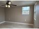 Bedroom features light gray walls, window, a ceiling fan, and new flooring at 1516 Culverhouse Dr, Daytona Beach, FL 32117