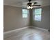 Bedroom with ceiling fan, wood-look floors, and natural light from multiple windows at 1516 Culverhouse Dr, Daytona Beach, FL 32117
