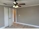Neutral bedroom featuring light gray walls, ceiling fan, and bi-fold closet doors at 1516 Culverhouse Dr, Daytona Beach, FL 32117