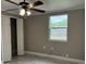 Bedroom featuring light gray walls, window, ceiling fan, and closet at 1516 Culverhouse Dr, Daytona Beach, FL 32117