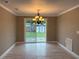 Bright dining area with chandelier and sliding glass doors to the backyard at 1516 Culverhouse Dr, Daytona Beach, FL 32117