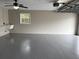 Garage interior featuring epoxy flooring and utility sink with new window at 1516 Culverhouse Dr, Daytona Beach, FL 32117