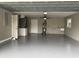 Garage interior featuring epoxy flooring, electric door, and utility sink at 1516 Culverhouse Dr, Daytona Beach, FL 32117