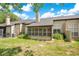 Backyard view featuring an enclosed patio and shutter windows offering scenic outdoor living space at 1525 Farrindon Cir, Lake Mary, FL 32746