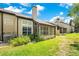 Cozy home exterior featuring a screened-in patio and lush green landscaping in the backyard at 1525 Farrindon Cir, Lake Mary, FL 32746