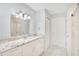 Modern bathroom with a granite countertop vanity, updated lighting, and a glass-enclosed shower with marble tiling at 1525 Farrindon Cir, Lake Mary, FL 32746