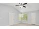 Well-lit bedroom with two doors, a window for natural light, and a ceiling fan for comfort at 1525 Farrindon Cir, Lake Mary, FL 32746