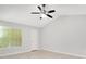 Bright bedroom with a ceiling fan, a window offering natural light, and an adjacent door at 1525 Farrindon Cir, Lake Mary, FL 32746