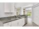 Open concept kitchen with stainless steel appliances, granite countertops, and white cabinets at 1525 Farrindon Cir, Lake Mary, FL 32746