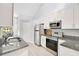 Modern kitchen with stainless steel appliances, granite countertops, and white cabinets at 1525 Farrindon Cir, Lake Mary, FL 32746