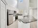 Bright kitchen with stainless steel appliances, white cabinets, and granite countertops at 1525 Farrindon Cir, Lake Mary, FL 32746