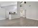 Open floor plan with vaulted ceiling, breakfast bar, and light wood-look flooring at 1525 Farrindon Cir, Lake Mary, FL 32746