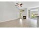 Bright living room features vaulted ceiling, fireplace, and wood-look flooring at 1525 Farrindon Cir, Lake Mary, FL 32746