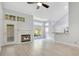 Cozy living room with vaulted ceiling, fireplace, breakfast bar, and light wood-look flooring at 1525 Farrindon Cir, Lake Mary, FL 32746