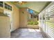 Inviting patio with shutter windows, slate flooring, a leaf-bladed ceiling fan, and a glass door at 1525 Farrindon Cir, Lake Mary, FL 32746