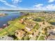 Expansive aerial view of a lakeside community featuring manicured lawns and beautiful homes at 16086 Johns Lake Overlook Dr, Winter Garden, FL 34787