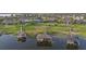 Aerial view of waterfront homes with private boat docks and a lush green neighborhood at 16086 Johns Lake Overlook Dr, Winter Garden, FL 34787