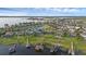 Aerial view of a lakeside community with boat docks, a community pond, and well-manicured lawns at 16086 Johns Lake Overlook Dr, Winter Garden, FL 34787